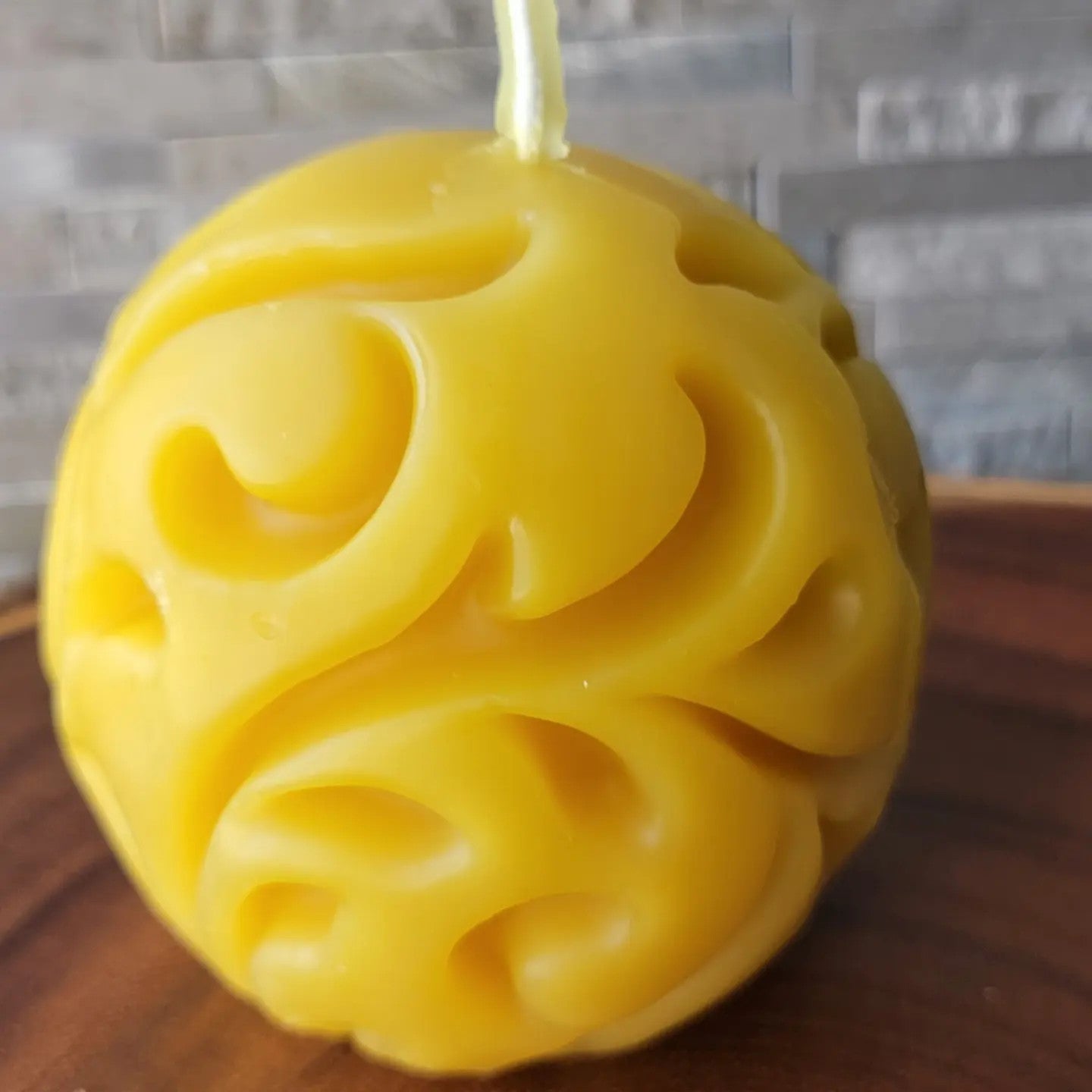 Circular beeswax candle with design