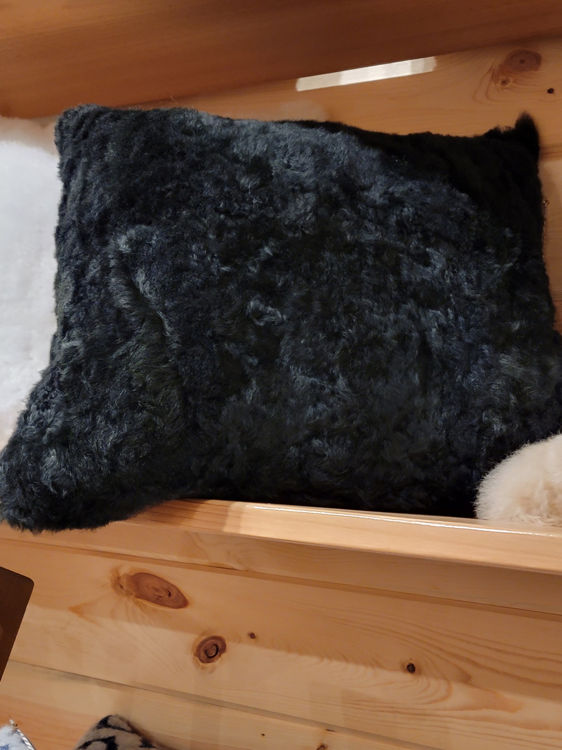 black fluffy pillows in a bin