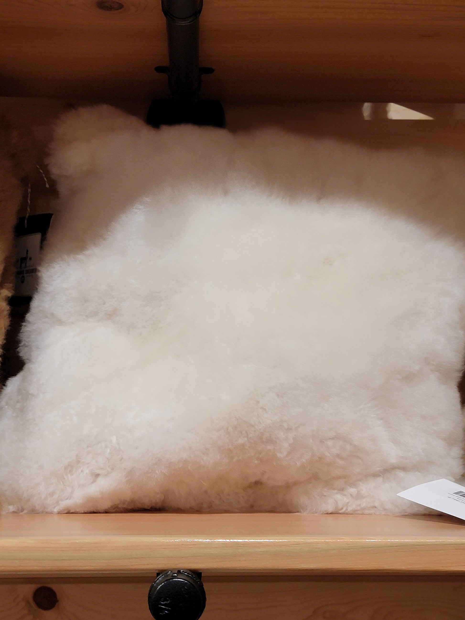 White fluffy pillow in a bin